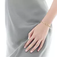 women wearing tiffany gold and diamond bracelet