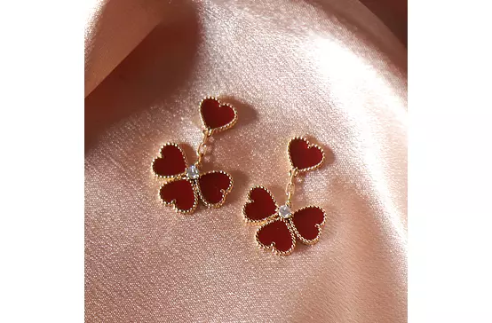 rent red alhambra earrings on satin