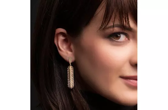 women wearing gold drop earrings