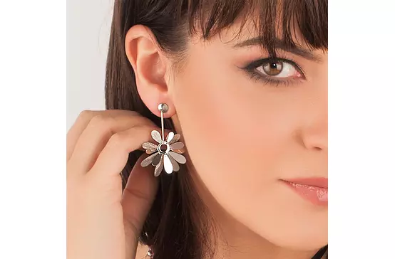 women wearing silver flower earrings