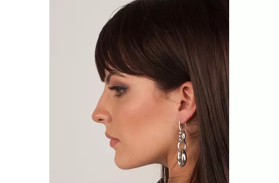 women wearing silver link earrings