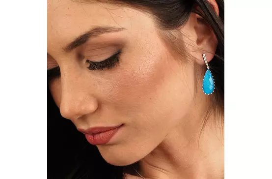 women wearing turquoise blue earrings
