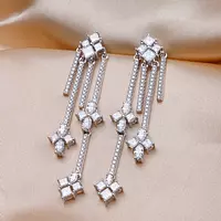 floral and geometric chandelier diamond earrings for rent on satin backdrop