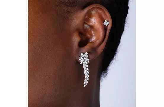 diamond cluster drop earrings for rent on a black model ear