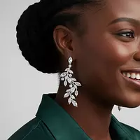 Rent diamond drop earrings with a leaf design on a model
