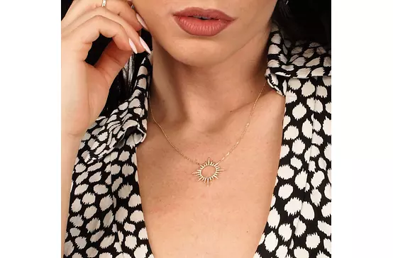 Burst pendant with diamonds for rent on model