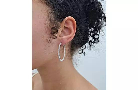 Large diamond hoop earrings on a model