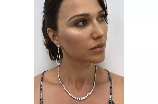 Diamond drop earrings for rent on a model