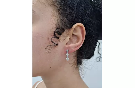 diamond drop earrings on a model 