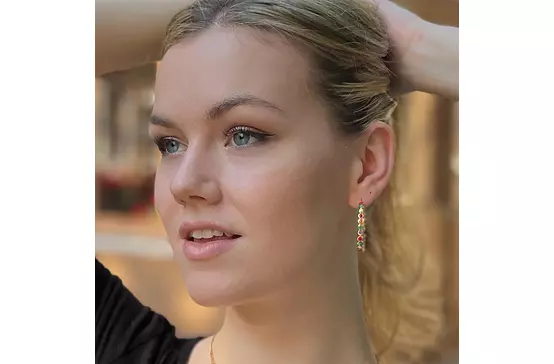 A model wearing the Enameled Gold Hoop Earrings.