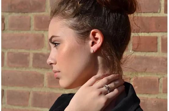 women wearing diamond stud earrings